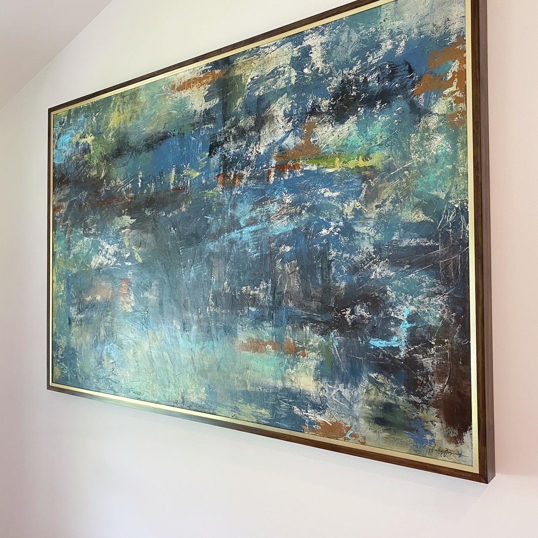 Large abstract painting in rich blue teal and gold tones with heavy impasto texture and expressive brushwork in walnut and gold float frame