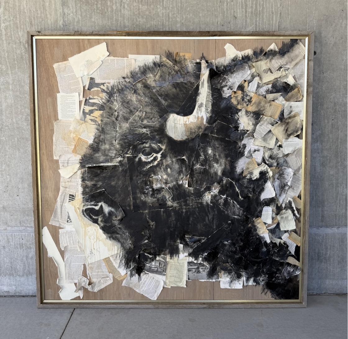 Dramatic mixed media portrait of a bison created with torn book pages charcoal and black paint on exposed wood panel with gold float frame