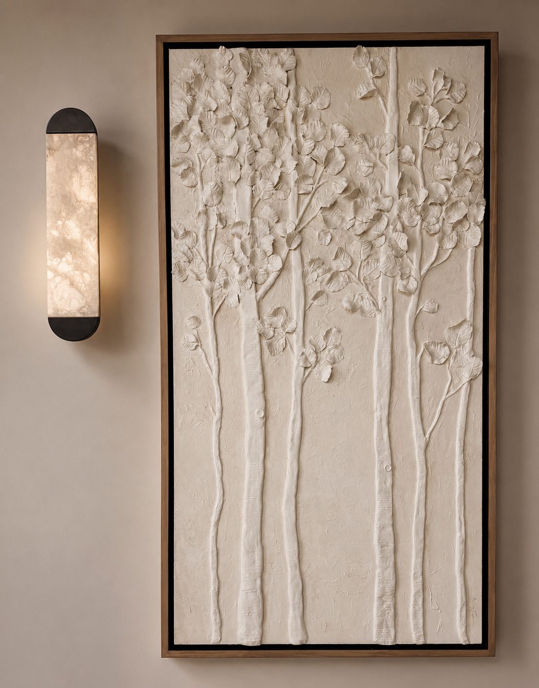 Tall white sculptural plaster relief of aspen trees and leaves in a walnut floater frame beside an alabaster wall sconce
